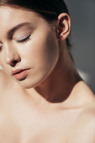 beautiful brunette naked girl with closed eyes on grey - Fotografie, Obrázek