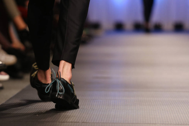 Το μοντέλο περπατάει στο διάδρομο του Fashion Show. Πόδια του μοντέλου στο διάδρομο πασαρέλας εκδήλωση. - Φωτογραφία, εικόνα
