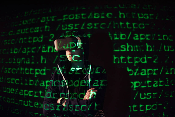 Double exposure of a caucasian man and Virtual reality VR headset is presumably a gamer or a hacker cracking the code into a secure network or server, with lines of code in green - Foto, Imagem