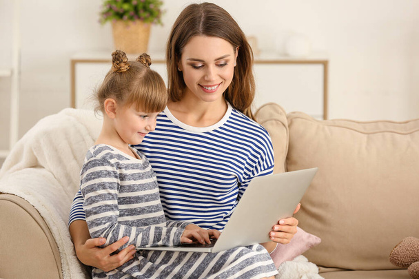 Happy mother and daughter with laptop at home - Φωτογραφία, εικόνα