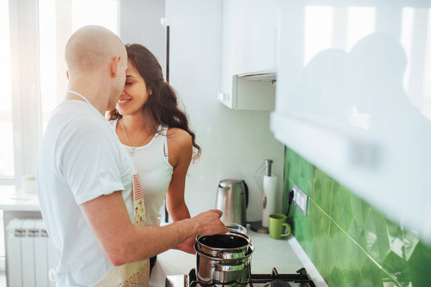 Happy young couple preparing on the stove. - Foto, Imagem