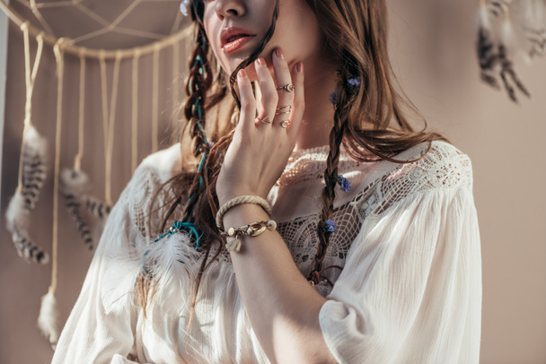 cropped view of girl with braids in white boho dress on beige with dream catcher - Foto, imagen