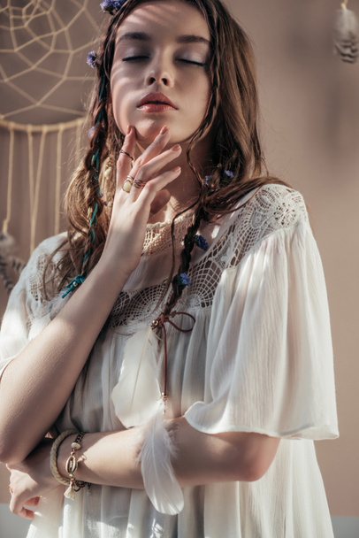tender girl with braids and closed eyes on beige with dream catcher - Fotografie, Obrázek