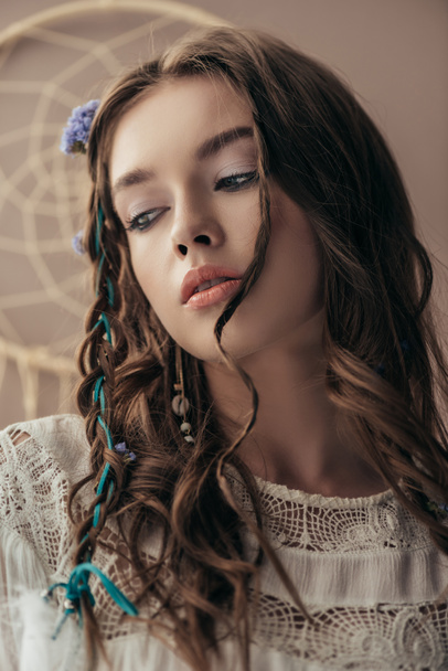 attractive tender girl with braids in white boho dress on beige with dream catcher - Фото, зображення