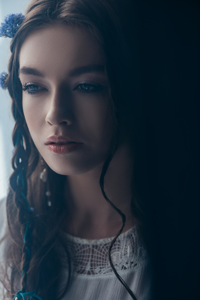 attractive tender girl with braids in white boho dress on grey - 写真・画像
