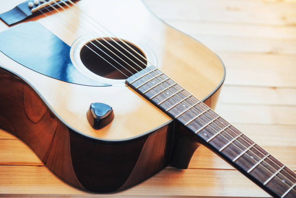 Photography classical guitar on a light brown background. - Φωτογραφία, εικόνα