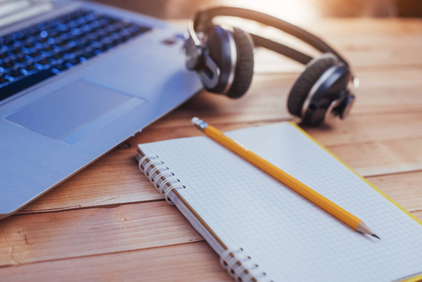Laptop notebook headphones and olivchem on a light wooden background - Φωτογραφία, εικόνα