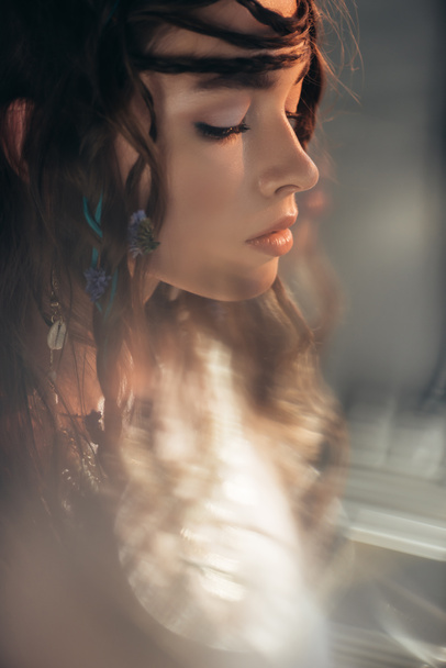 beautiful boho girl with braids in hairstyle posing on grey with lens flares  - Photo, Image