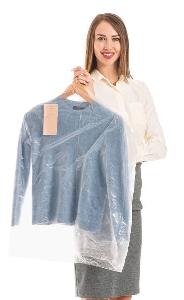 Trabalhadora da moderna lavandaria a seco com roupas em fundo branco
 - Foto, Imagem