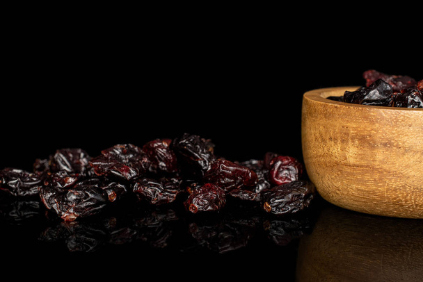 Dried cowberry isolated on black glass - Фото, изображение