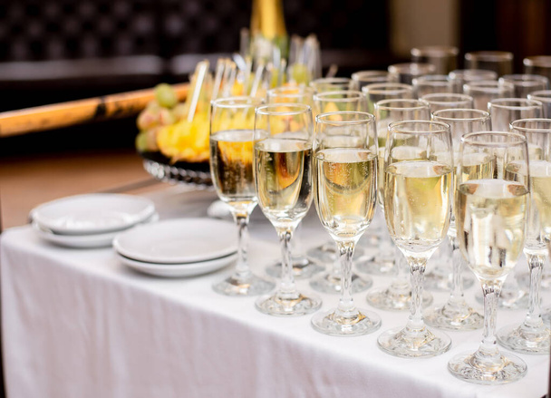 close-up άποψη της αφρώδους σαμπάνιας σε ποτήρια στο εορταστικό τραπέζι, έννοια γιορτή  - Φωτογραφία, εικόνα