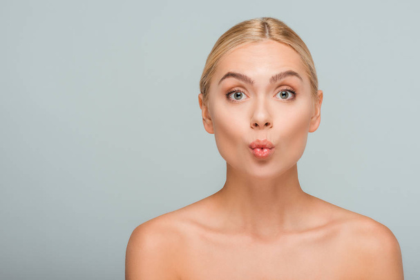 beautiful naked woman with duck face looking at camera isolated on grey  - Photo, Image
