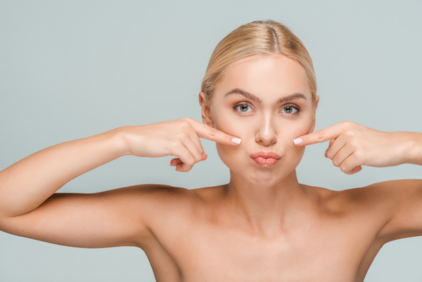 naked woman pointing with fingers at clean face isolated on grey  - Photo, Image