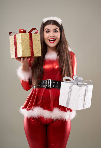 Beautiful young Santa girl with presents to give - Фото, изображение