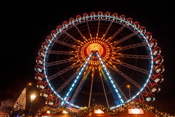 Illuminated Ferris Wheel at Christmas market in Berlin Germany - Photo, Image