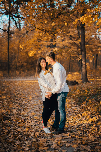 happy young couple hugging in autumn park - Zdjęcie, obraz