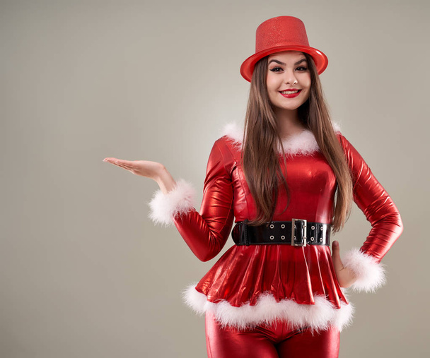Closeup shot of a beautiful Santa helper girl in red costume - Foto, immagini