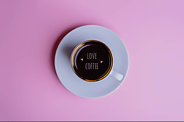 Cup of coffee on a saucer on a pale pink background. - Photo, image