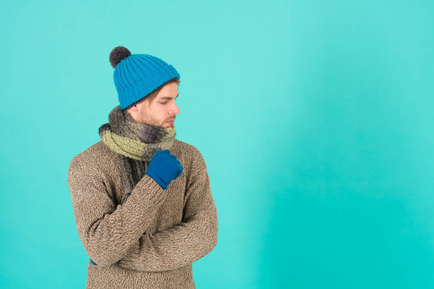 Copy space for advertisement. Man handsome unshaven guy wear winter accessories on blue background. Winter season sale. Hipster knitted winter hat scarf and gloves. Shopping concept. Clothes shop - Photo, image