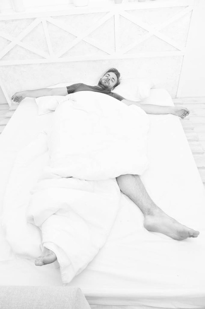Get enough amount of sleep every night. Bearded man face relaxing. Maintaining consistent circadian rhythm essential for general health. Man handsome guy relaxing in bed. Relaxing before fall asleep - Фото, изображение