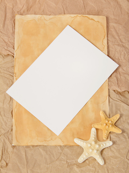 Old paper, two starfishes and blank card - Фото, изображение