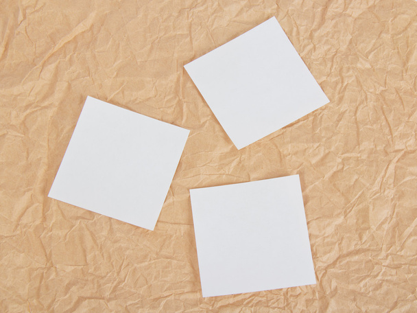 Three white cards on packing paper. Background - 写真・画像