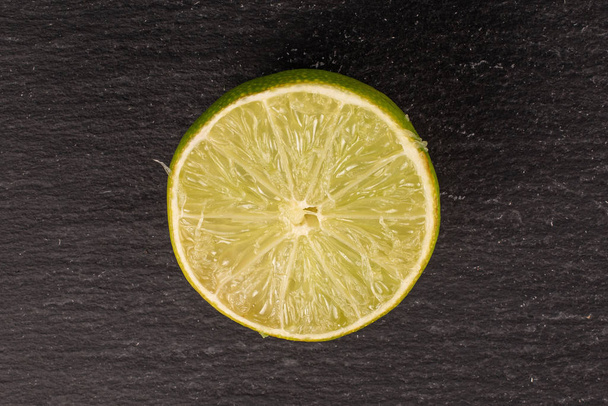 Green sour lime on grey stone - Фото, зображення