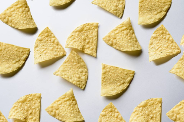 An overhead shot of nachos on a white surface - great for background - Foto, immagini