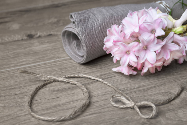 Fragile pink hyacinth and linen napkin on wood - Foto, Imagem