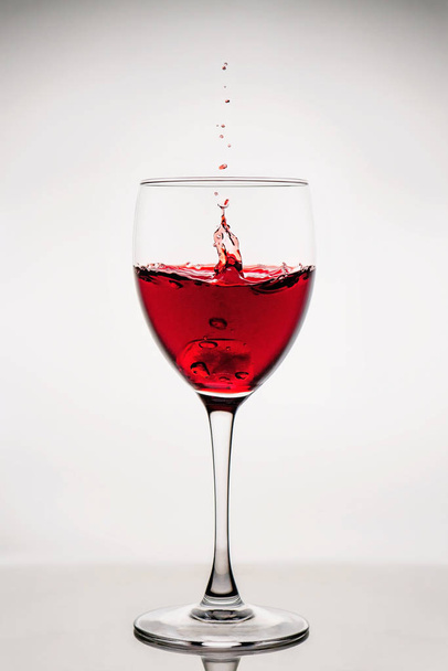 Red wine splash in the wineglass - Zdjęcie, obraz