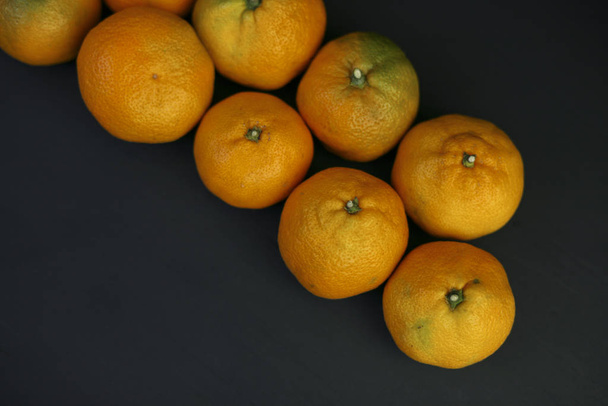 tangerines on a black background. healthy food concept, eco-friendly natural products, vegetarian, raw, organic, Tropical abstract background. - Φωτογραφία, εικόνα