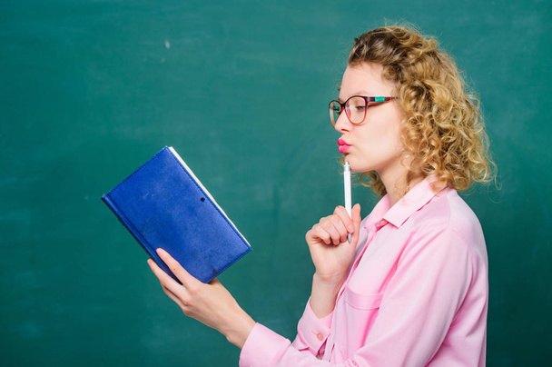 Woman school teacher in front of chalkboard. Passionate about knowledge. Teacher explain hard topic. Teacher best friend of learners. Pedagogue hold book and explaining information. Education concept - Fotoğraf, Görsel