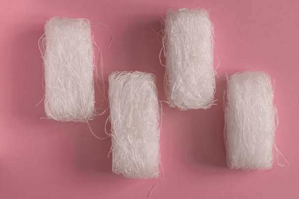 Asian uncooked cellophane noodles  on a pink background top view flat lay pattern - 写真・画像