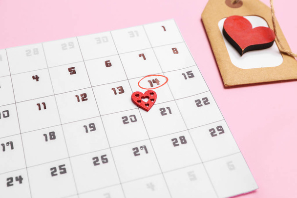 Calendar with marked date of Valentine's Day on color background - Photo, Image