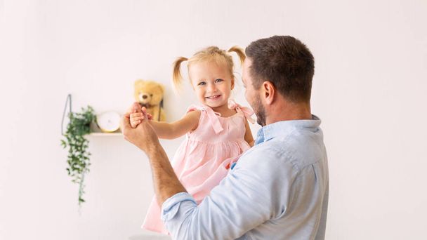 Millennial father dancing with his adorable baby - Photo, Image