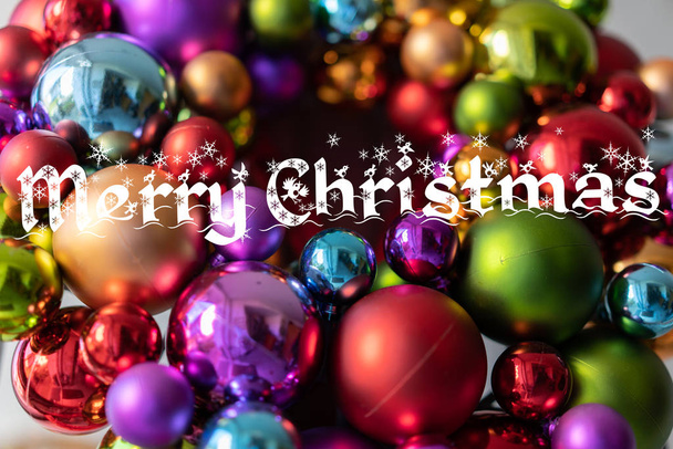 Christmas Card: Letters of Merry Christmas on decoration with colorful christmas balls. - Foto, Imagem