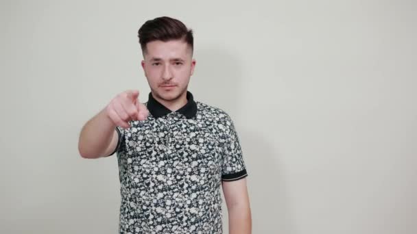 Young caucasian man over isolated gray background showing thumb down - Video