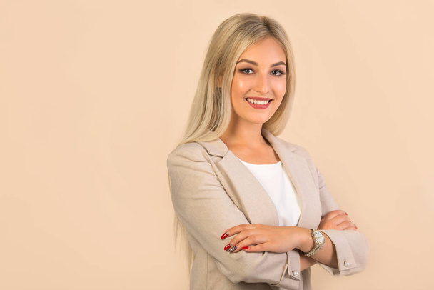 beautiful young woman in suit on beige background - Φωτογραφία, εικόνα