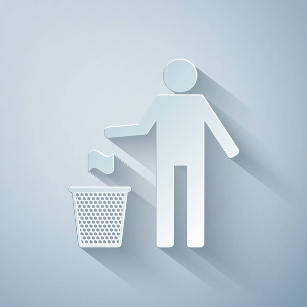 Paper cut Man throwing trash into dust bin icon isolated on grey background. Recycle symbol. Trash can sign. Paper art style. Vector Illustration - Vector, Image