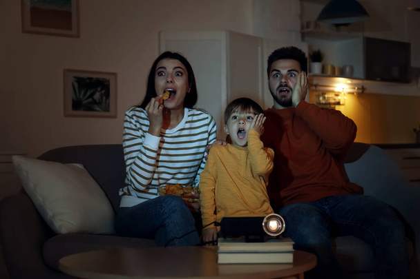 Emotional family watching movie using video projector at home - Photo, Image