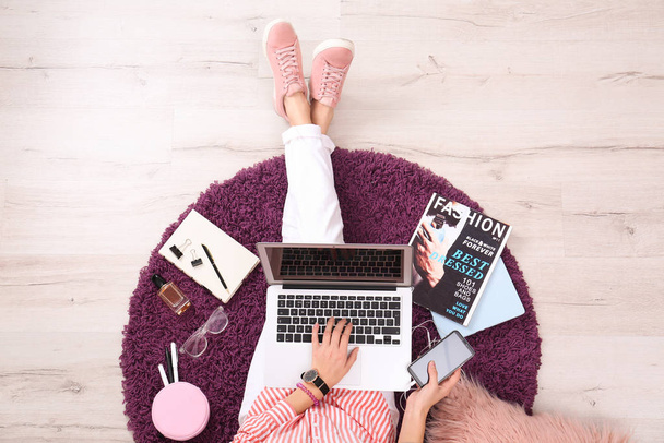 Fashion blogger with laptop sitting on floor, top view - Photo, image