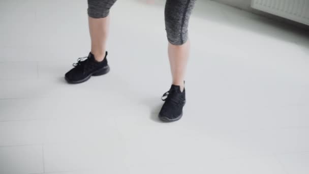 closeup on sportswoman legs in sneakers making exercizes. fitness, weight loss - Felvétel, videó