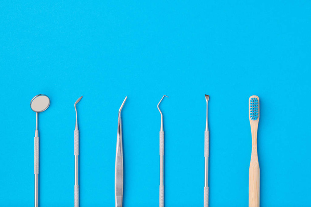 Dentist tools over blue background top view - Φωτογραφία, εικόνα
