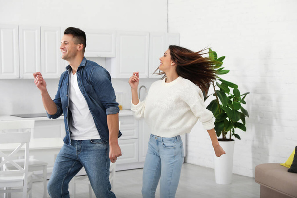 Happy couple dancing in kitchen at home - Fotografie, Obrázek