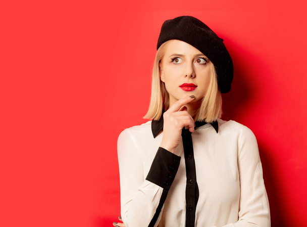 beautiful french woman in beret on red background - Photo, Image