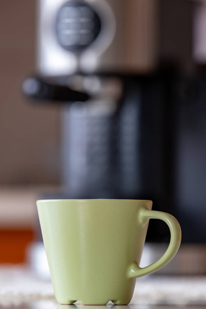 Coffee cup and coffee maker on the kitchen table.  - Fotoğraf, Görsel