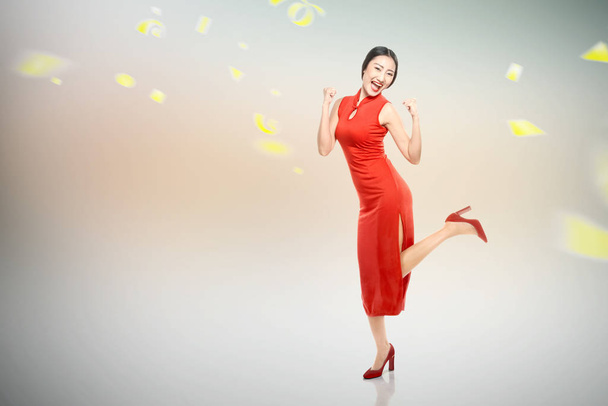 Asian Chinese woman in a cheongsam dress celebrates Chinese New  - Φωτογραφία, εικόνα