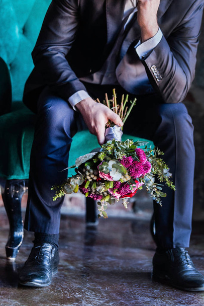 wedding bouquet in hands of man  - Fotó, kép
