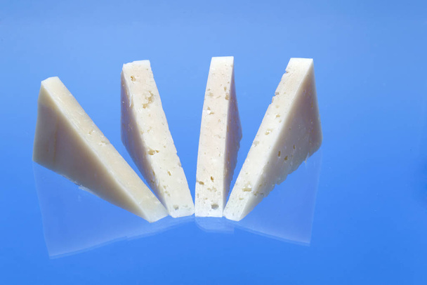 Wedges of cured Manchego cheese. - 写真・画像