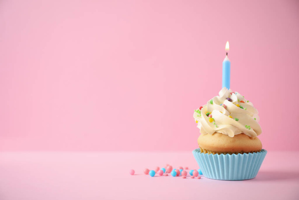 Delicious birthday cupcake with candle on pink background. Space - Fotografie, Obrázek